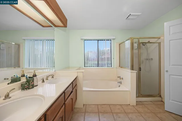 a bathroom with a tub sink and mirror