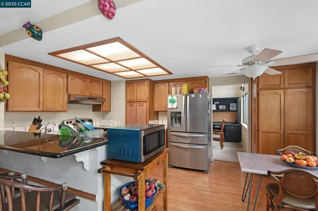 a kitchen with stainless steel appliances granite countertop a refrigerator and a stove