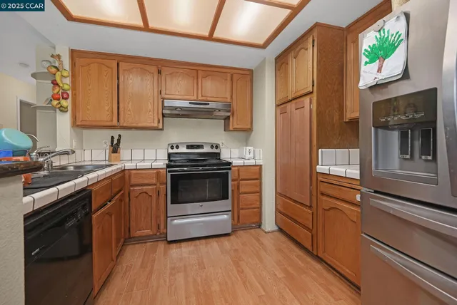 a kitchen with stainless steel appliances a stove sink and microwave