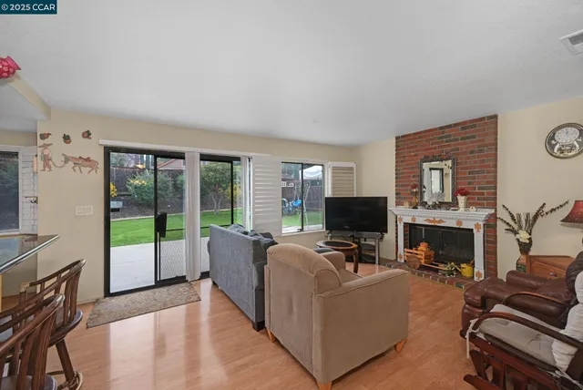 a living room with furniture a fireplace and a flat screen tv