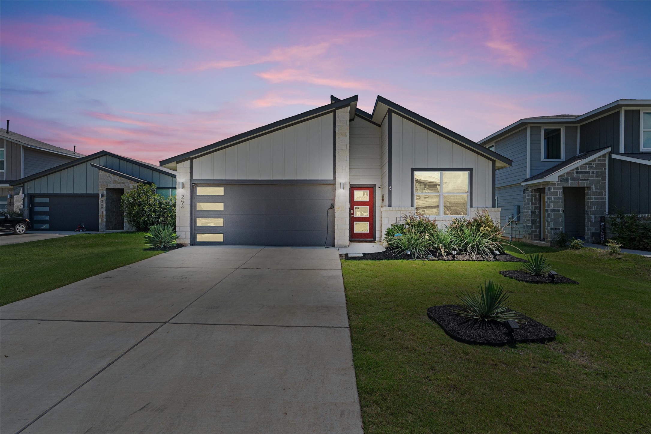 253 Century Plant Road Leander, TX 78641 - Photo 1 of 1 View of front facade with an attached garage, a yard, and driveway