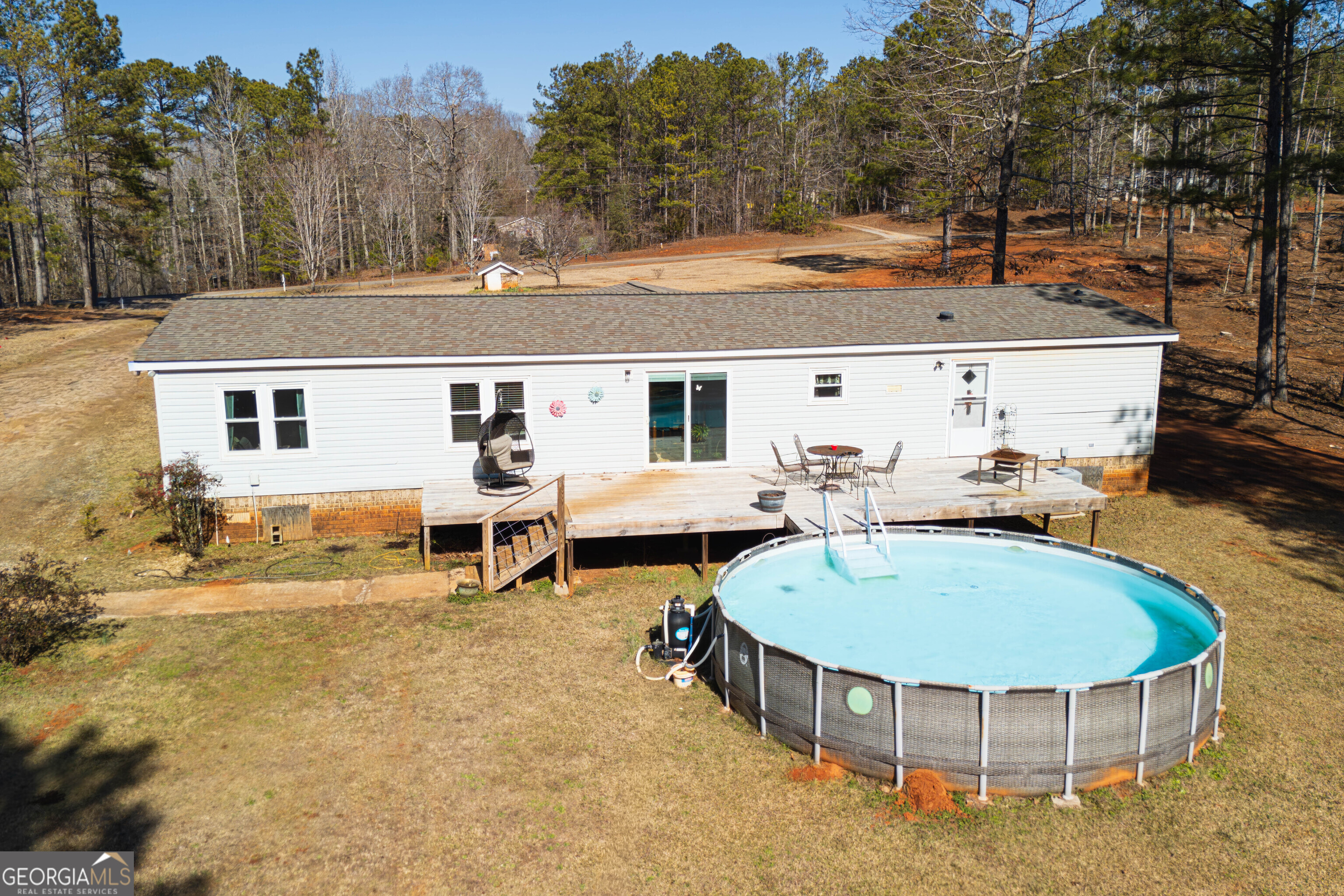 161 Cherokee Trail Forsyth, GA 31029 - Photo 17 of 39 a view of a white house with swimming pool and sitting area