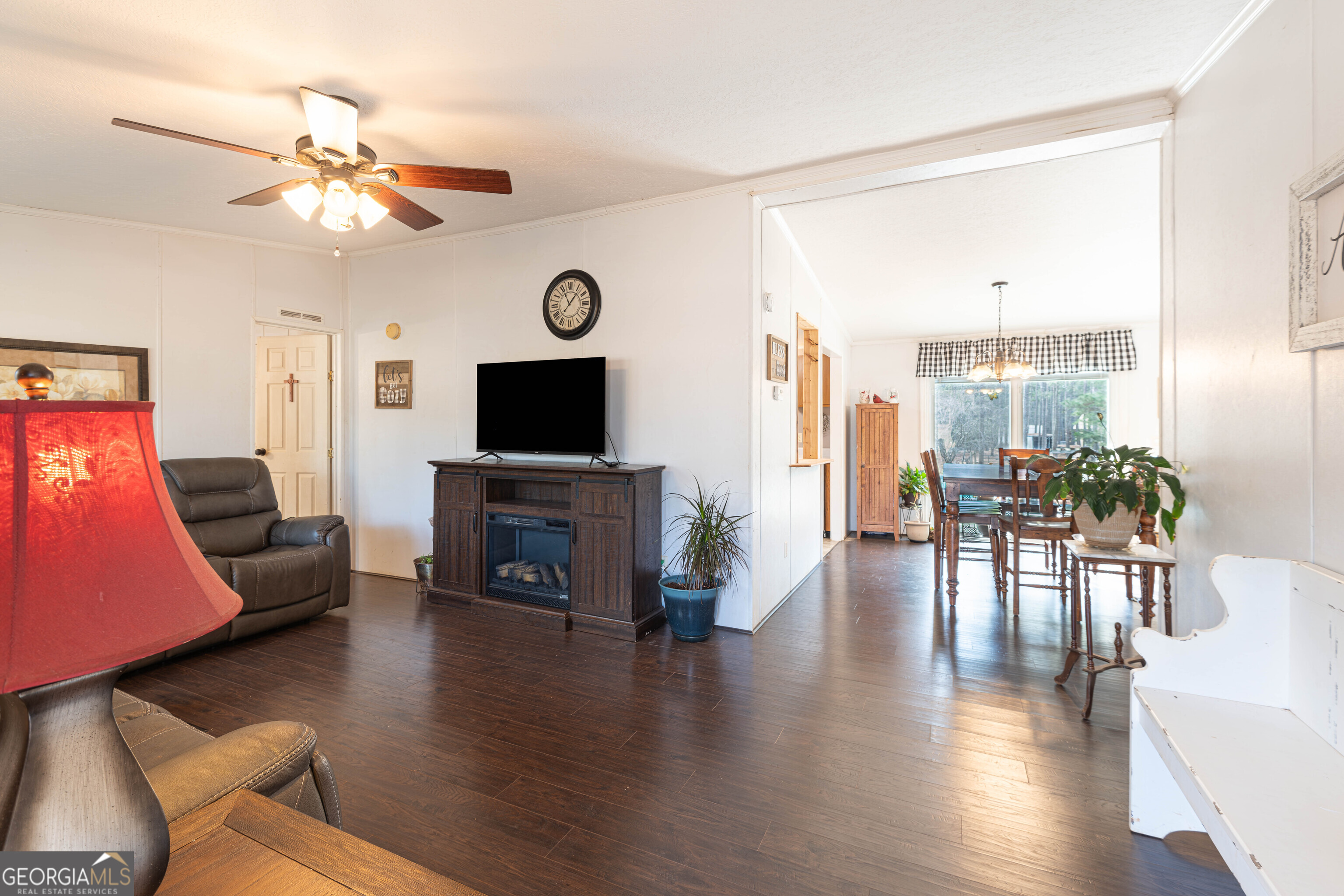 161 Cherokee Trail Forsyth, GA 31029 - Photo 23 of 39 a living room with furniture a fireplace and a flat screen tv