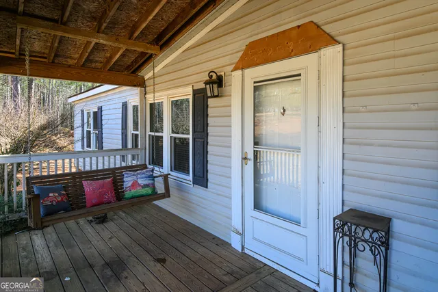 a view of a deck with wooden floor and furniture