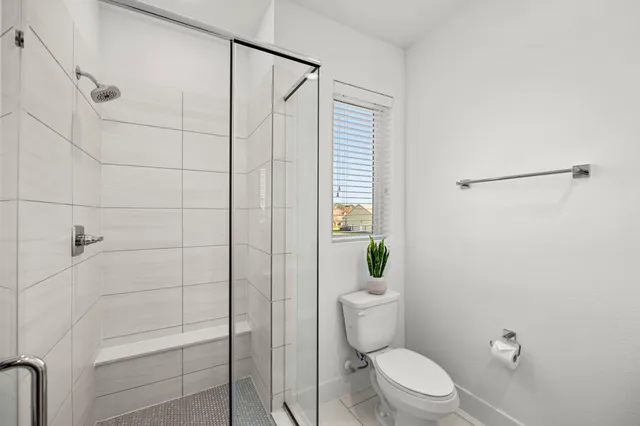 a bathroom with a toilet a sink and a window