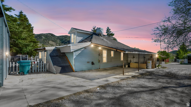 44 Shriver Street Eureka, UT 84628 - Photo 42 of 43 Light blue siding exterior featuring multiple windows and a covered carport