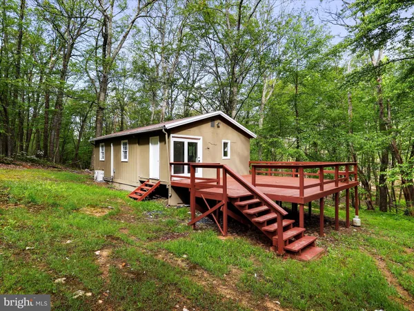 a view of a house with a backyard and sitting area