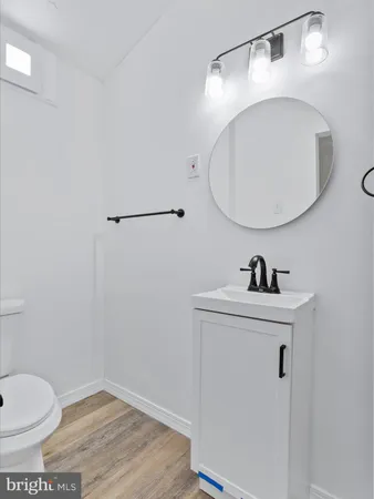 a bathroom with a toilet a sink and mirror