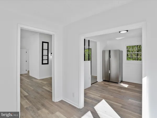 an empty room with closet and windows