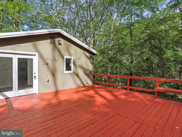 a view of backyard with deck and wooden floor