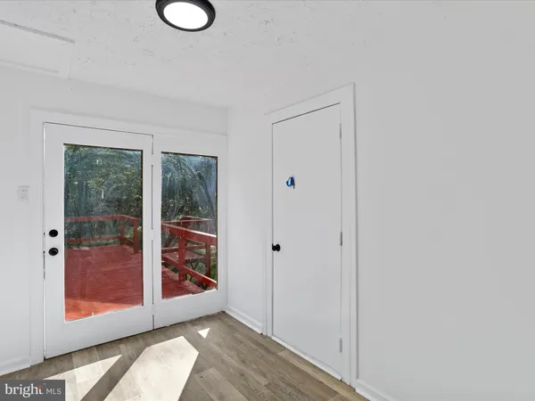 a view of an empty room with glass door