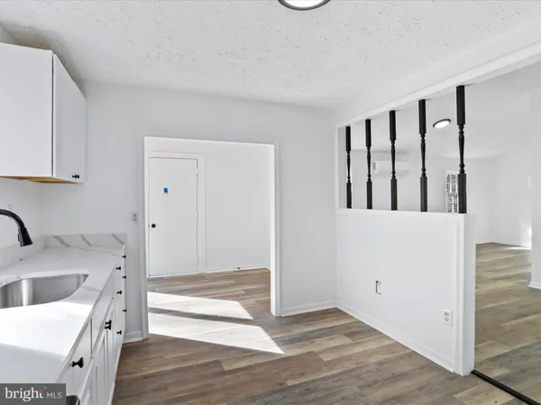 a view of a kitchen with an empty space and a sink