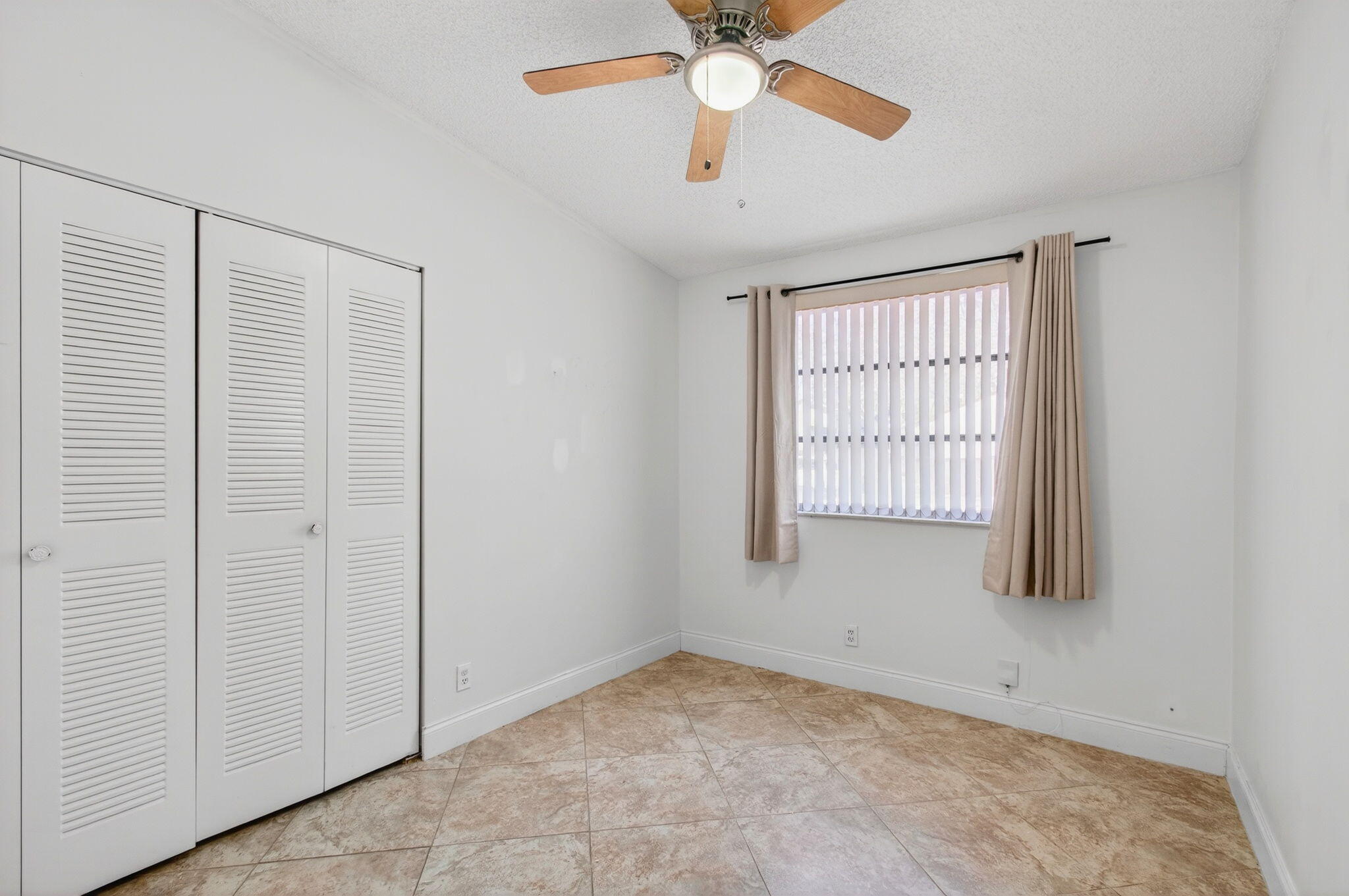 11609 Orange Blossom Lane Boca Raton, FL 33428 - Photo 12 of 30 an empty room with windows and fan