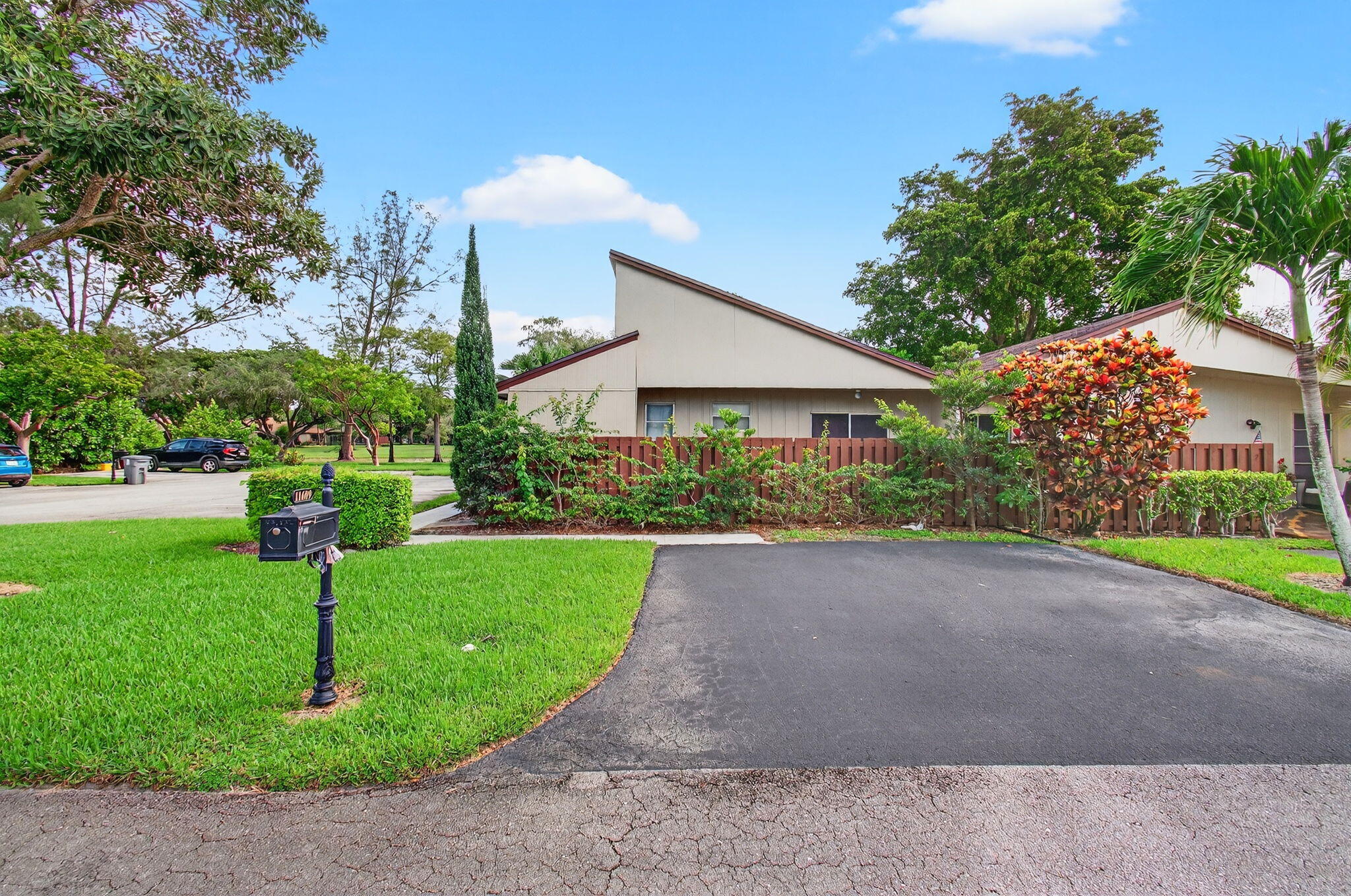 11609 Orange Blossom Lane Boca Raton, FL 33428 - Photo 17 of 30 a front view of a house with a yard and potted plants