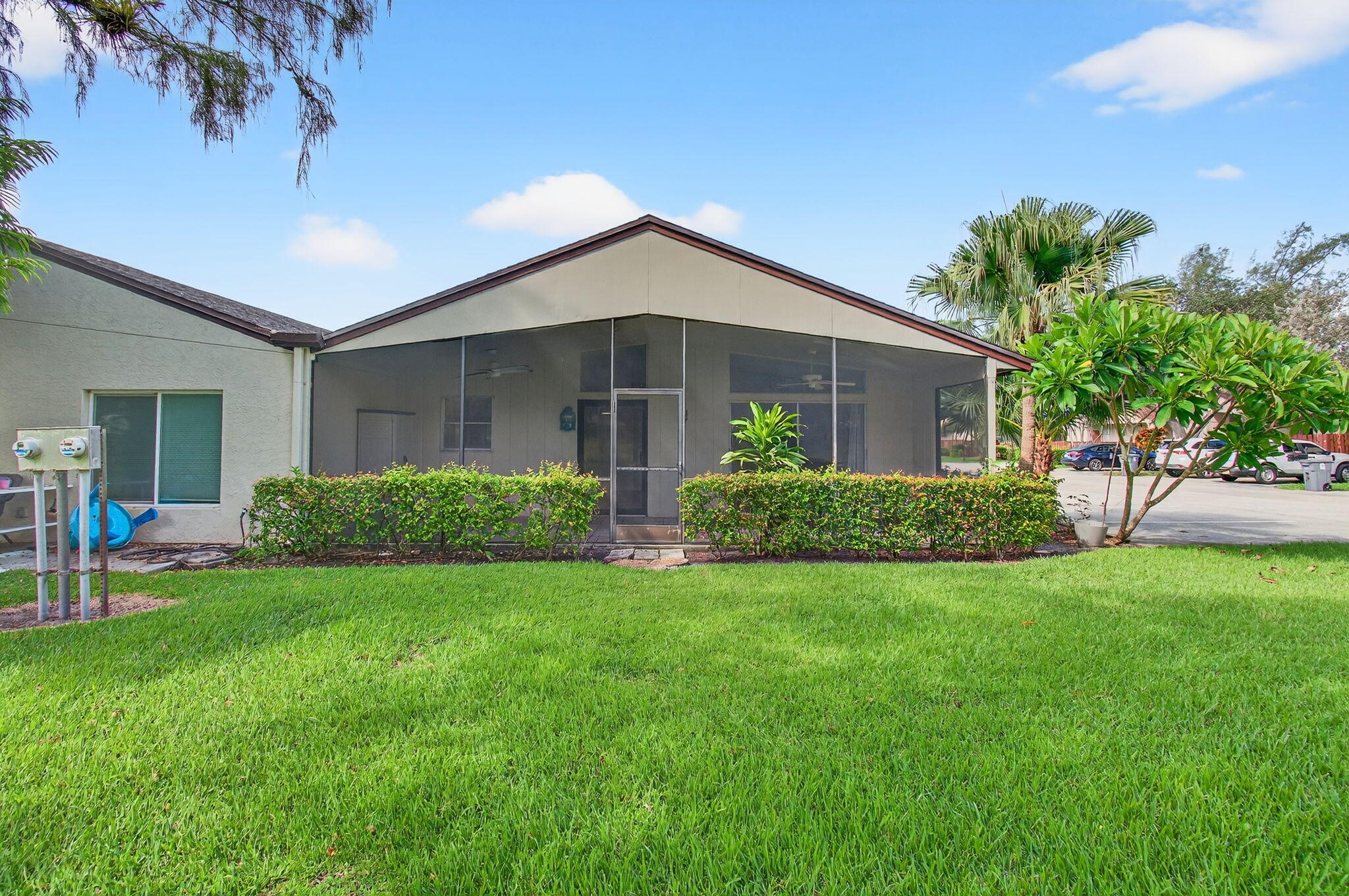 11609 Orange Blossom Lane Boca Raton, FL 33428 - Photo 19 of 30 a front view of a house with a yard and porch