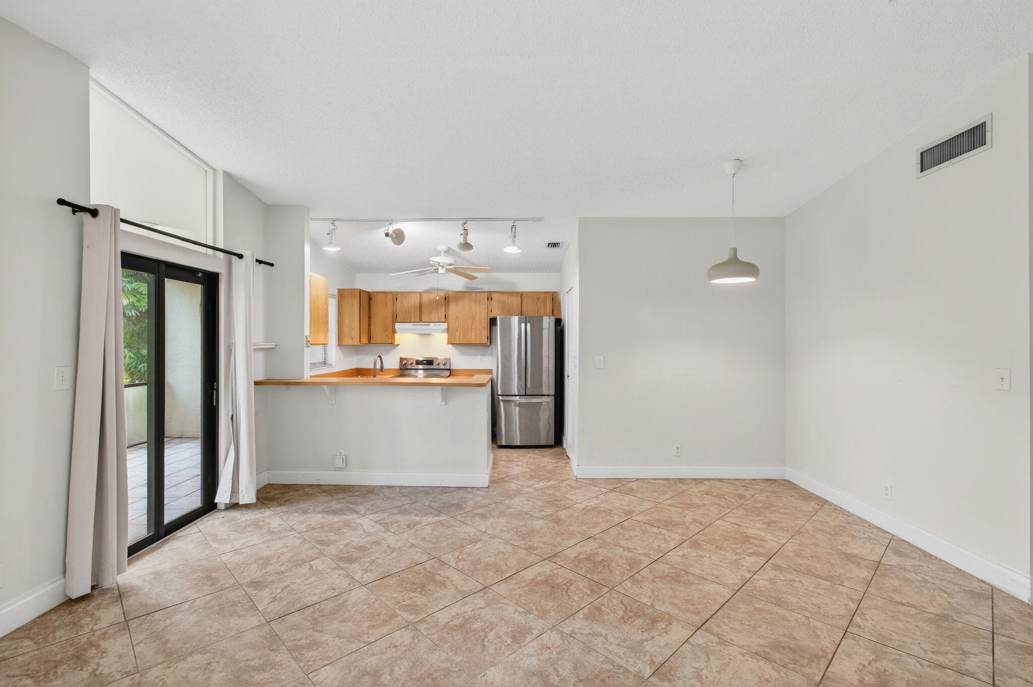 11609 Orange Blossom Lane Boca Raton, FL 33428 - Photo 30 of 30 a view of a kitchen with refrigerator and windows