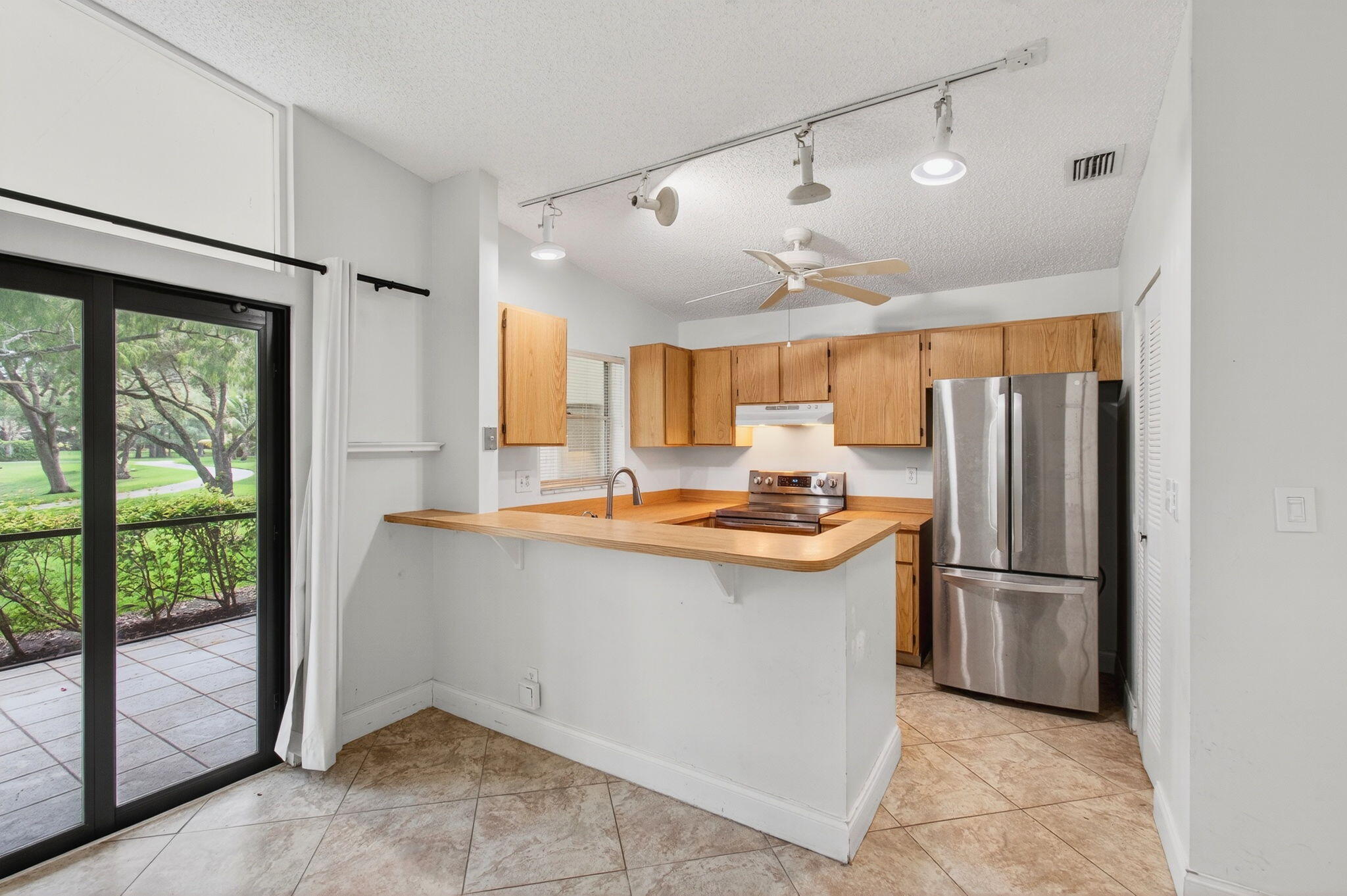 11609 Orange Blossom Lane Boca Raton, FL 33428 - Photo 5 of 30 a kitchen with granite countertop a refrigerator and a sink