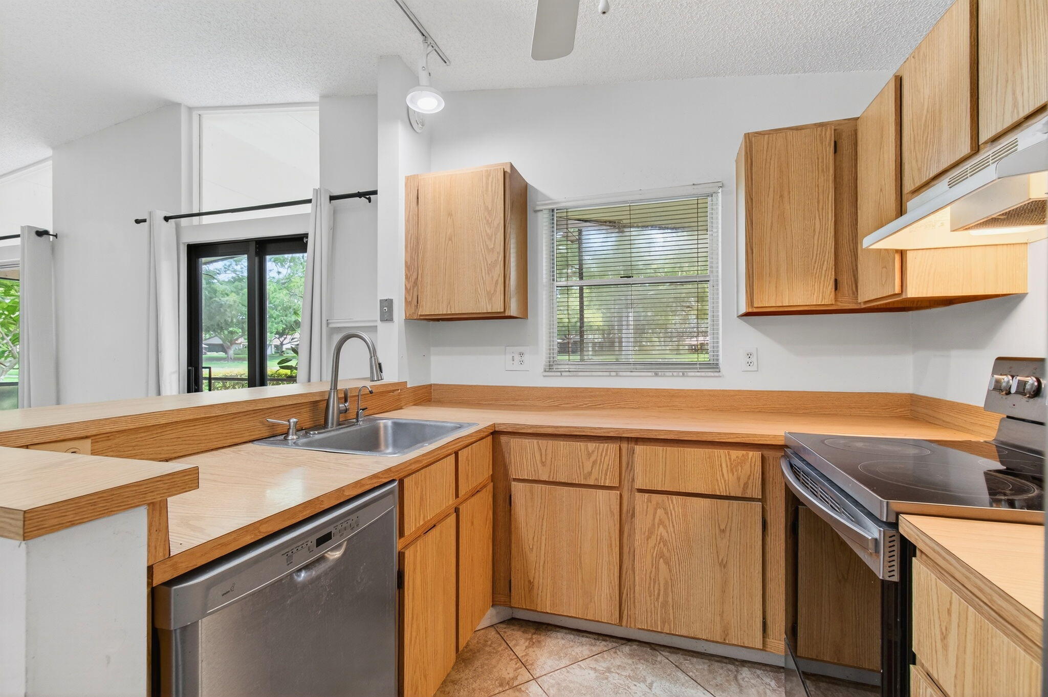 11609 Orange Blossom Lane Boca Raton, FL 33428 - Photo 6 of 30 a kitchen with a sink stove and cabinets