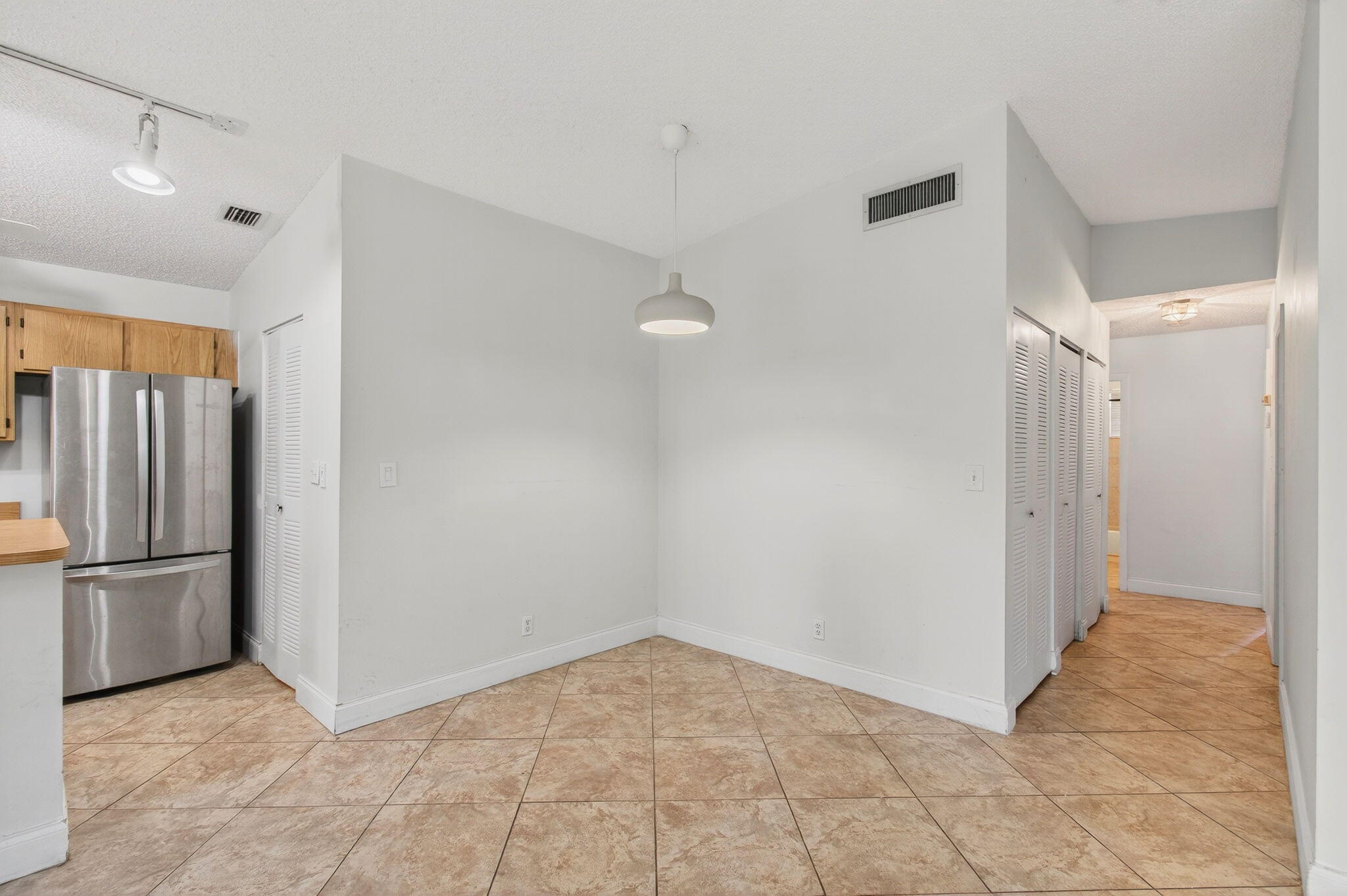11609 Orange Blossom Lane Boca Raton, FL 33428 - Photo 7 of 30 a view of a refrigerator in kitchen and an empty room