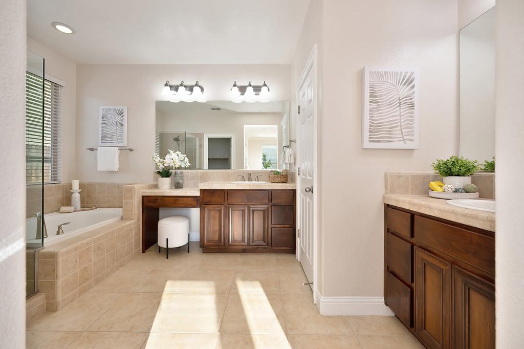 1964 Hartsfield Way Lincoln, CA 95648 - Photo 30 of 37 a spacious bathroom with a double vanity sink a mirror a bathtub and a window