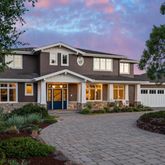 a bedroom with a bed and painting on the wall