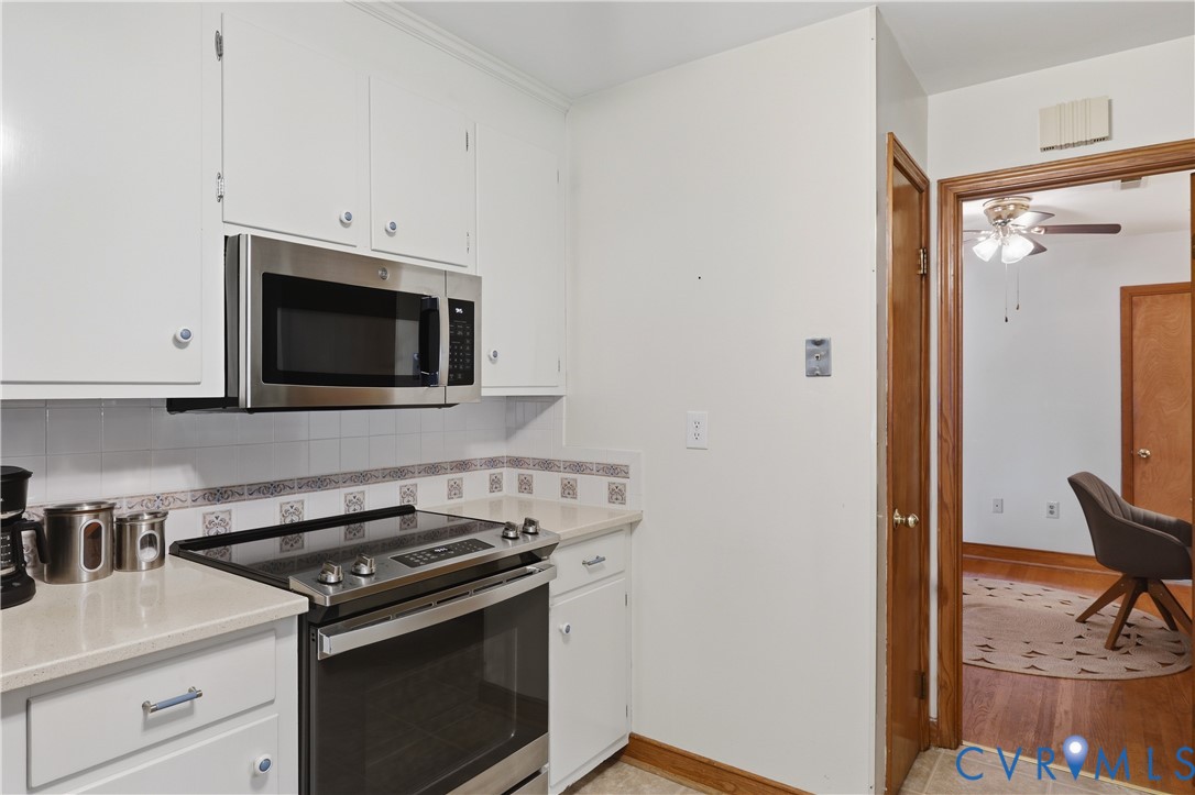 5210 Ronson Road North Chesterfield, VA 23234 - Photo 16 of 35 Kitchen featuring white cabinetry, light-toned cou