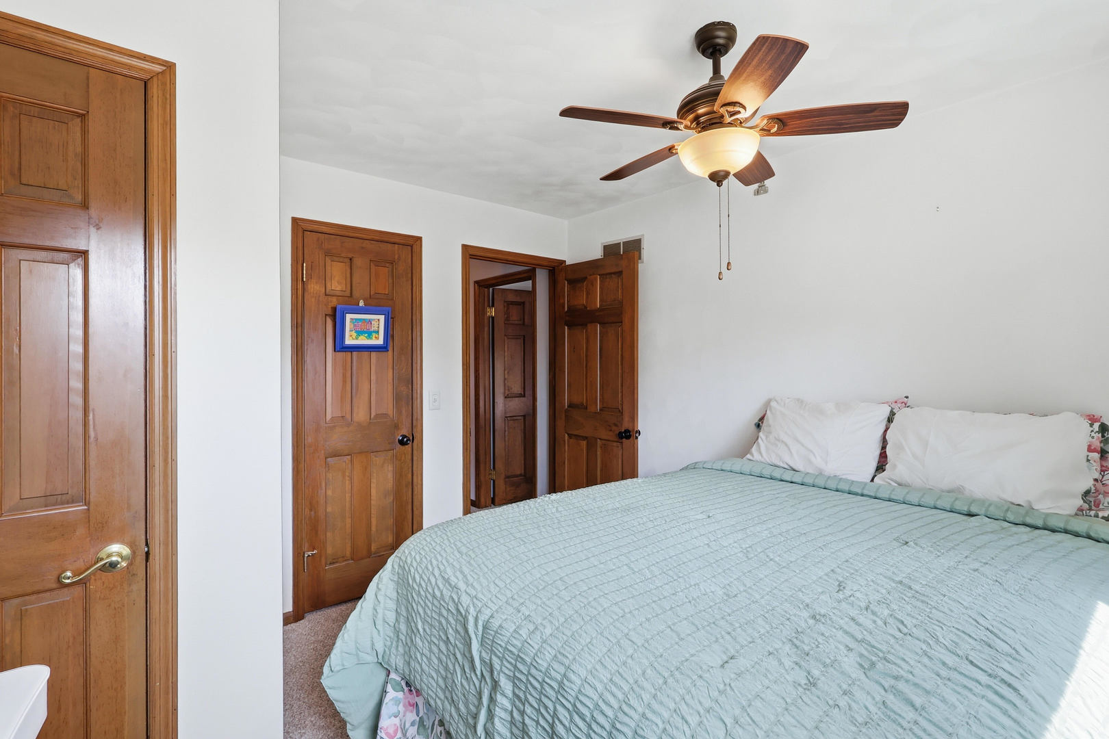 4314 Spring Street Davenport, IA 52807 - Photo 38 of 51 a bedroom with a bed and a chandelier
