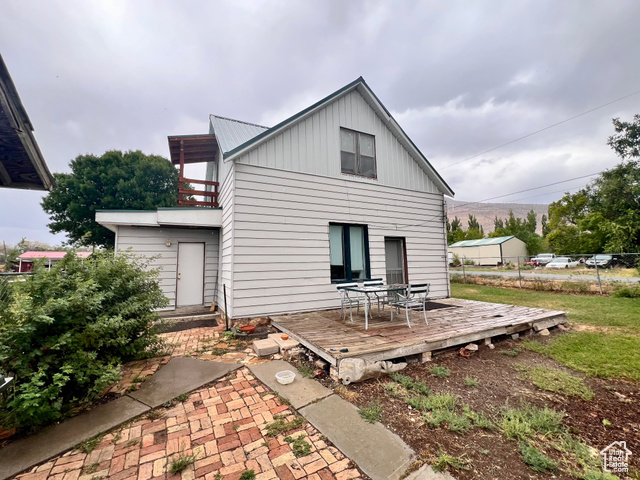 350 West Main Street Emery, UT 84522 - Photo 1 of 28 Back of property featuring a balcony, board and batten siding, and a wooden deck