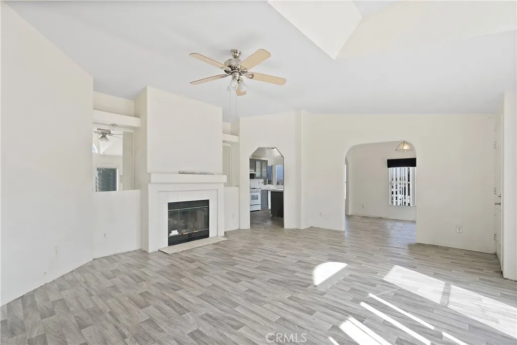 22540 Markham Street Perris, CA 92570 - Photo 12 of 20 a view of empty room with wooden floor and fireplace