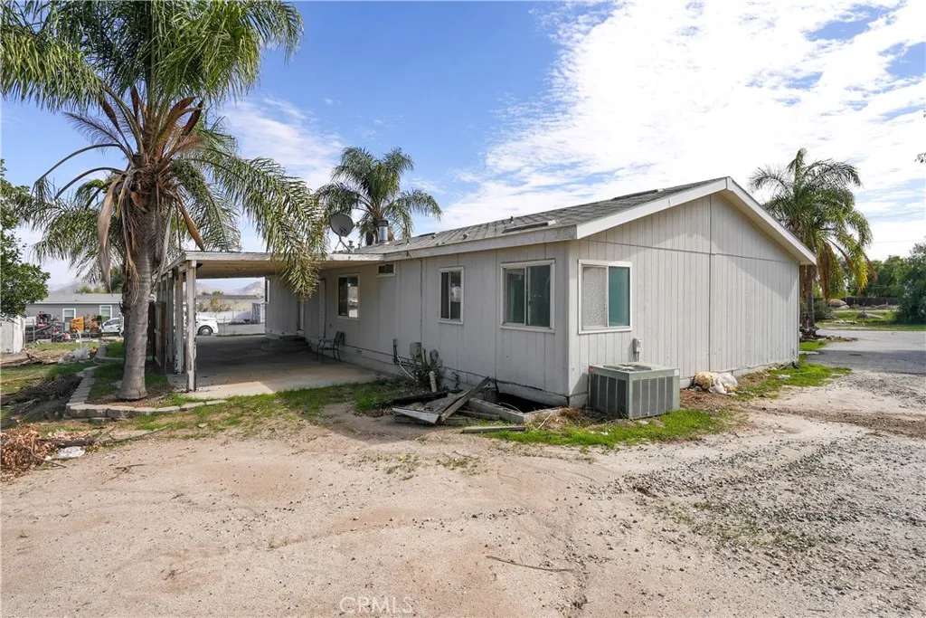 22540 Markham Street Perris, CA 92570 - Photo 16 of 20 a view of a house with backyard space and a tree