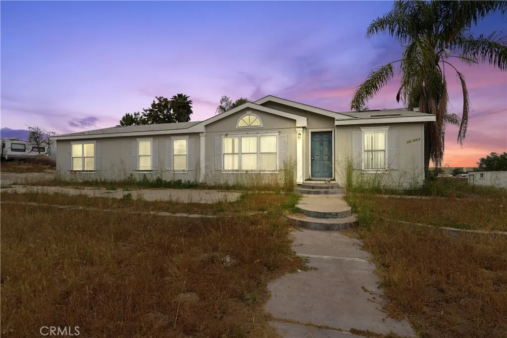 22540 Markham Street Perris, CA 92570 - Photo 2 of 20 a front view of a house with a yard