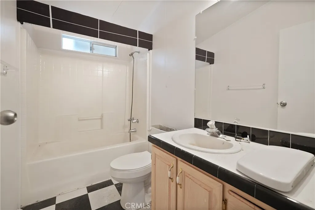 22540 Markham Street Perris, CA 92570 - Photo 4 of 20 a bathroom with a sink a toilet and shower