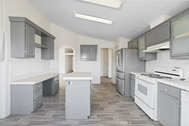 a view of empty room with wooden floor and fireplace