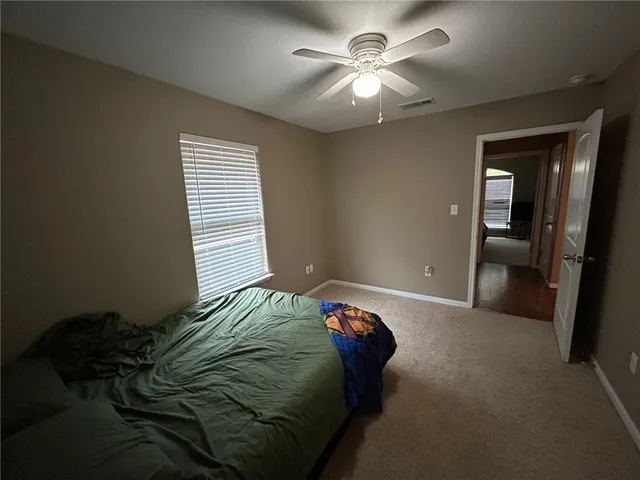 a bed sitting in a bedroom next to a window