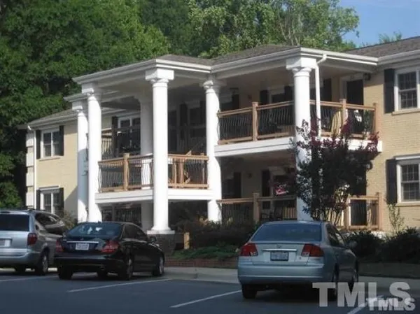 a front view of a house with car parked