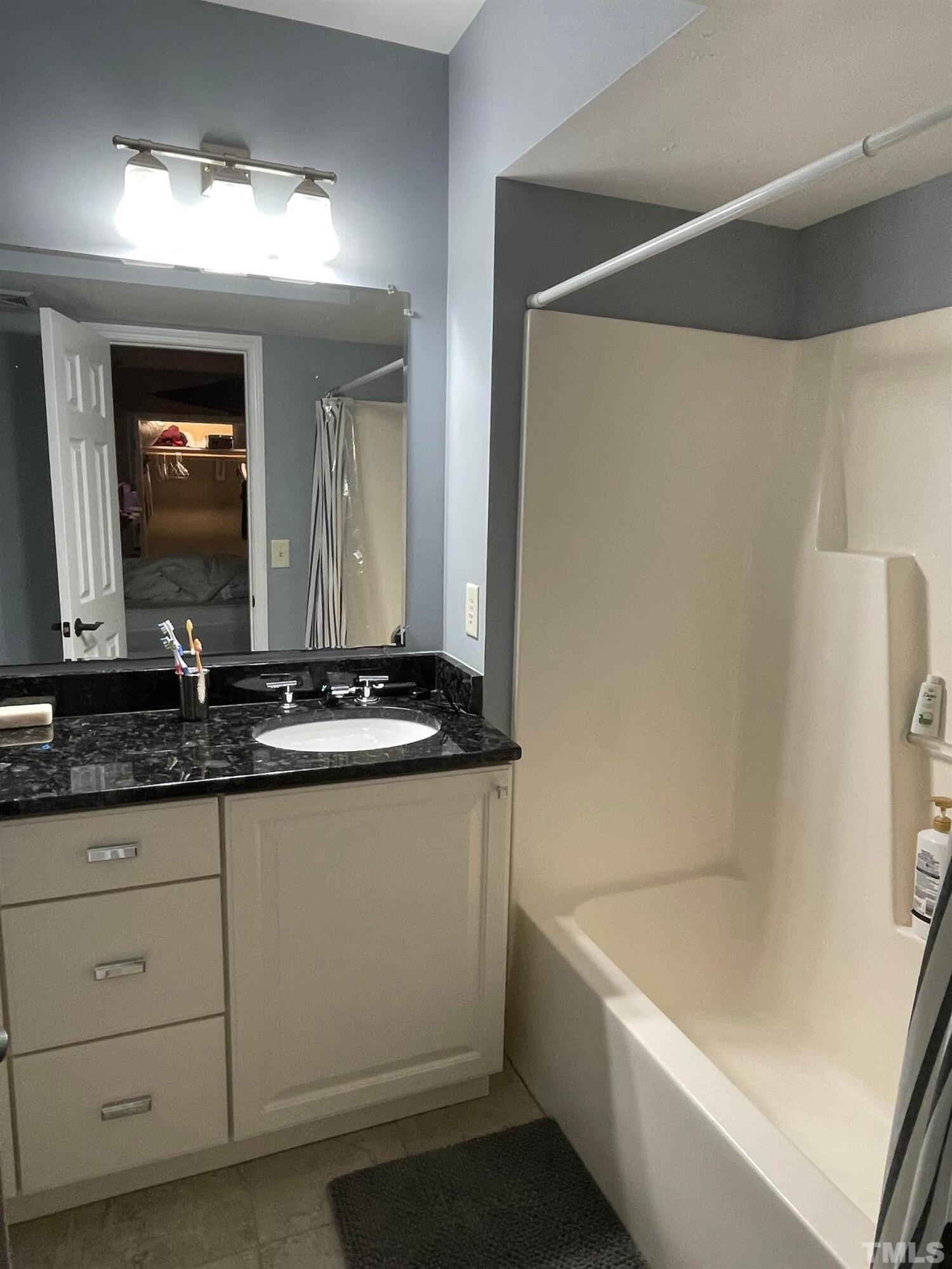 720 Bilyeu Street, Unit 203 Raleigh, NC 27606 - Photo 13 of 13 a bathroom with a bathtub and a sink