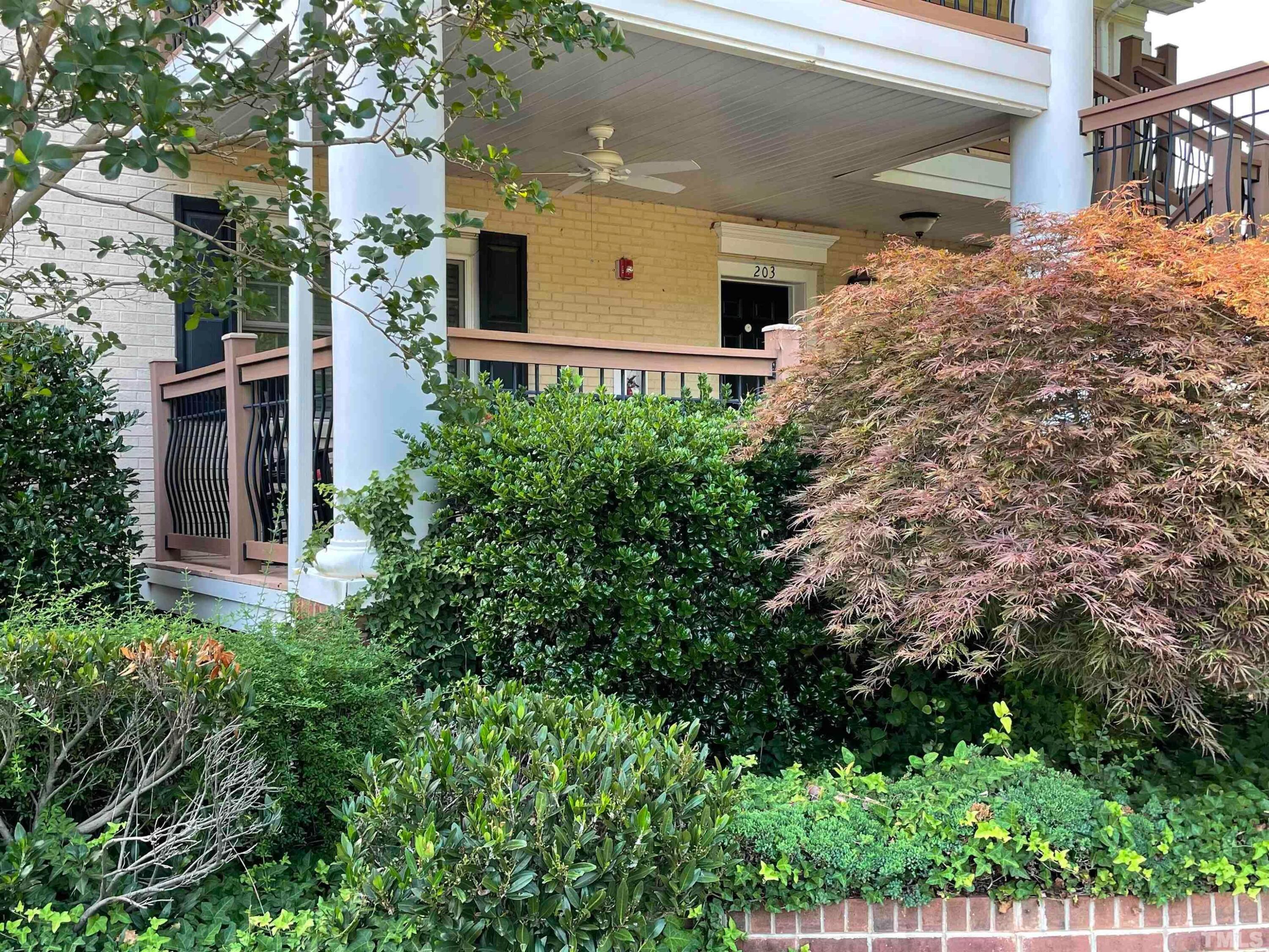 720 Bilyeu Street, Unit 203 Raleigh, NC 27606 - Photo 2 of 13 front view of a house with a yard
