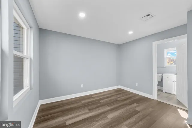 a view of room with window and wooden floor