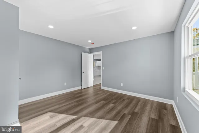 wooden floor in an empty room with a window