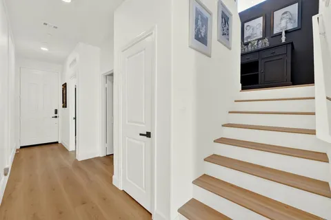 a view of an entryway with wooden floor and staircase