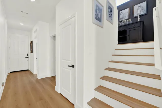 a view of an entryway with wooden floor and staircase