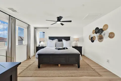 a bedroom with a bed and a chandelier