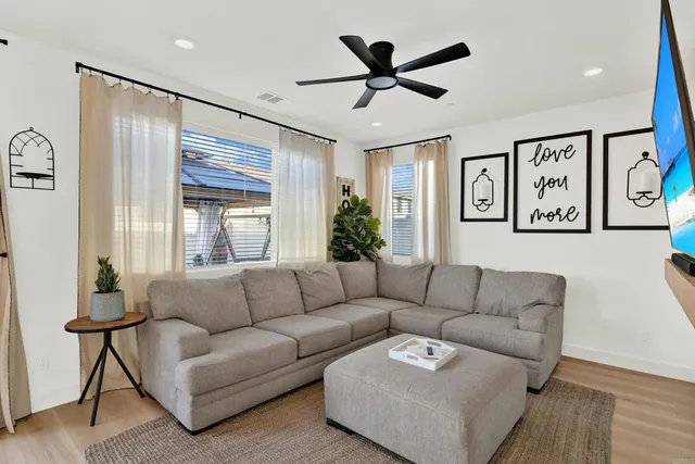 a living room with furniture and a large window