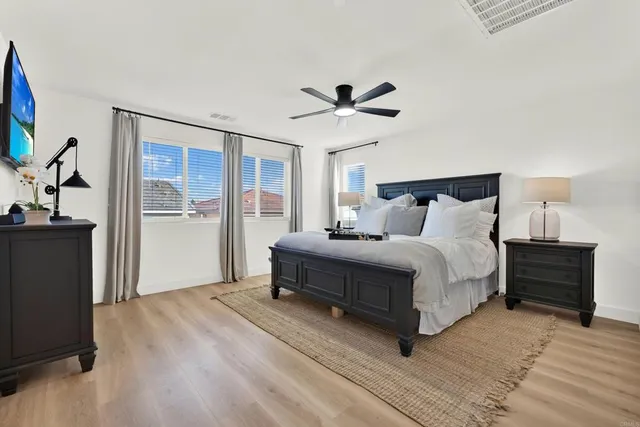 a spacious bedroom with a bed and a window