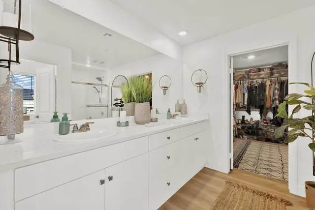 a bathroom with double vanity sink and a mirror