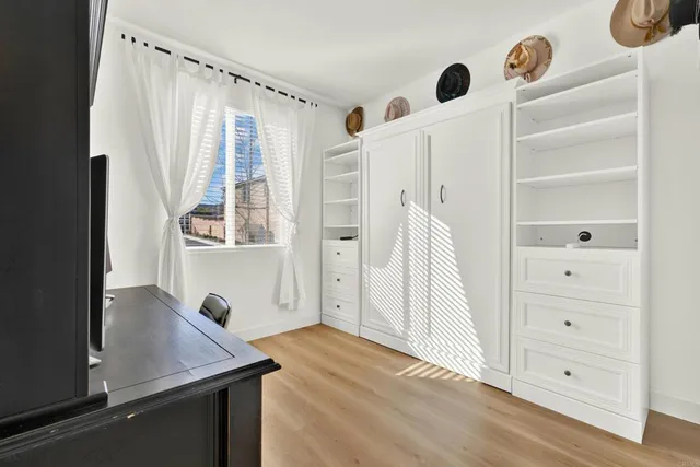 a view of walk in closet with clothes and shoes