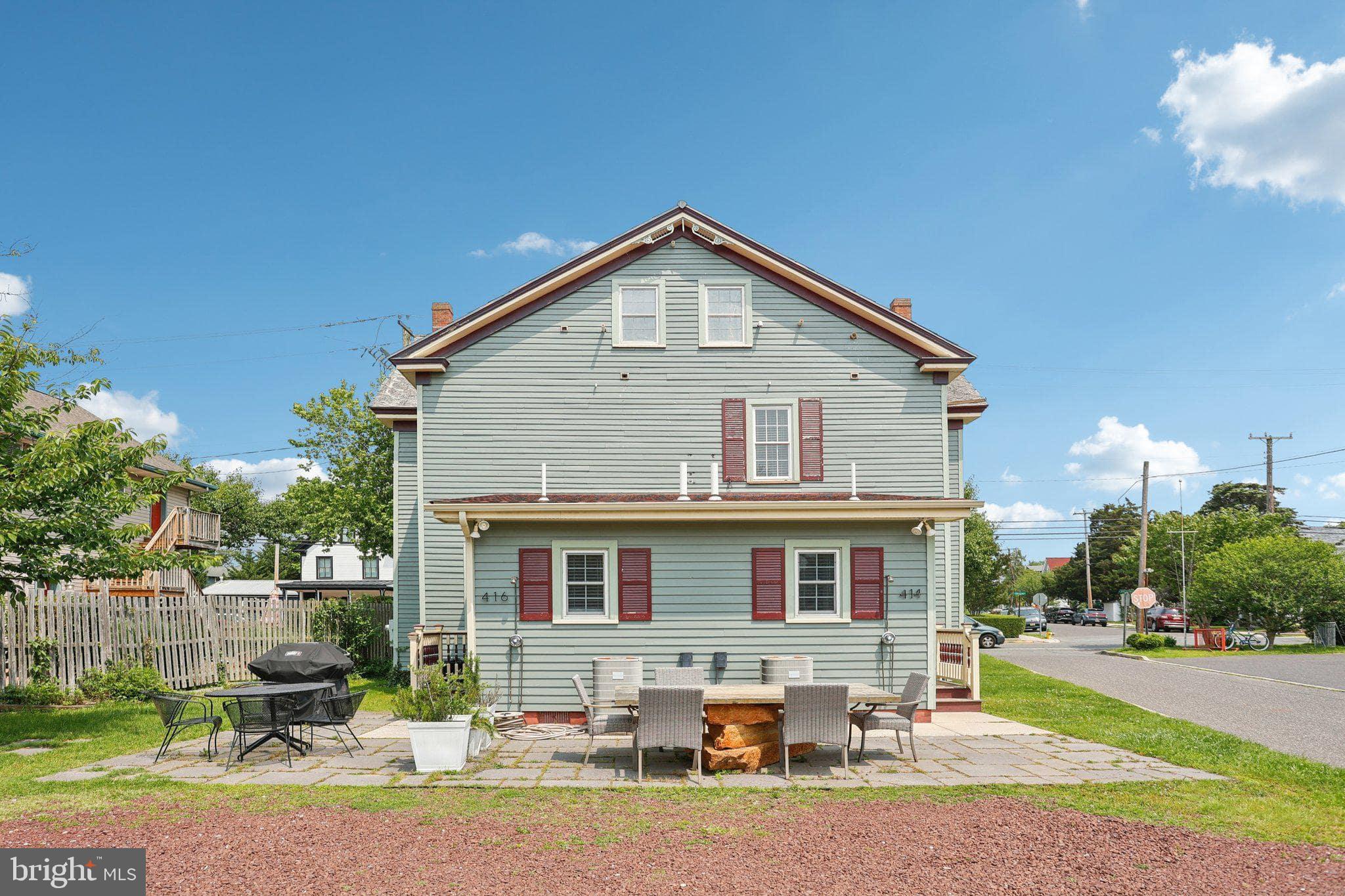 414 Broadway Cape May, NJ 08204 - Photo 16 of 48 a front view of a house with a yard outdoor seating and lake view