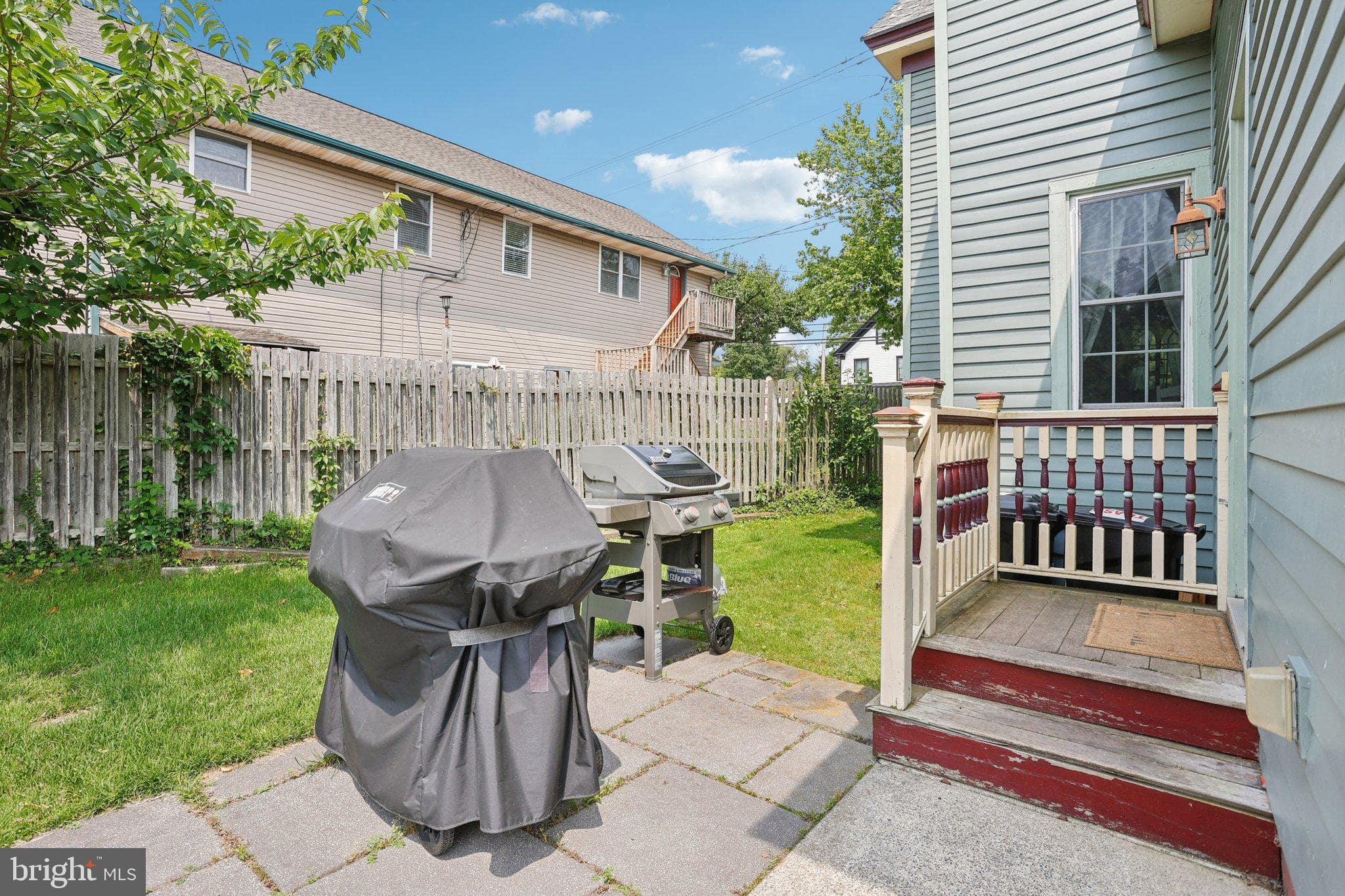 414 Broadway Cape May, NJ 08204 - Photo 20 of 48 a view of a deck with a table and chairs with wooden fence and plants