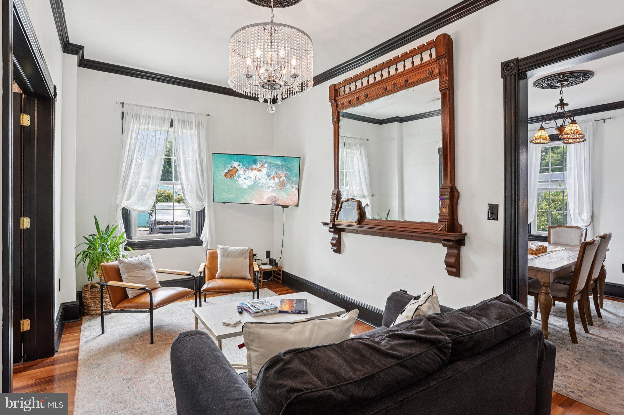 414 Broadway Cape May, NJ 08204 - Photo 26 of 48 a living room with furniture and a chandelier
