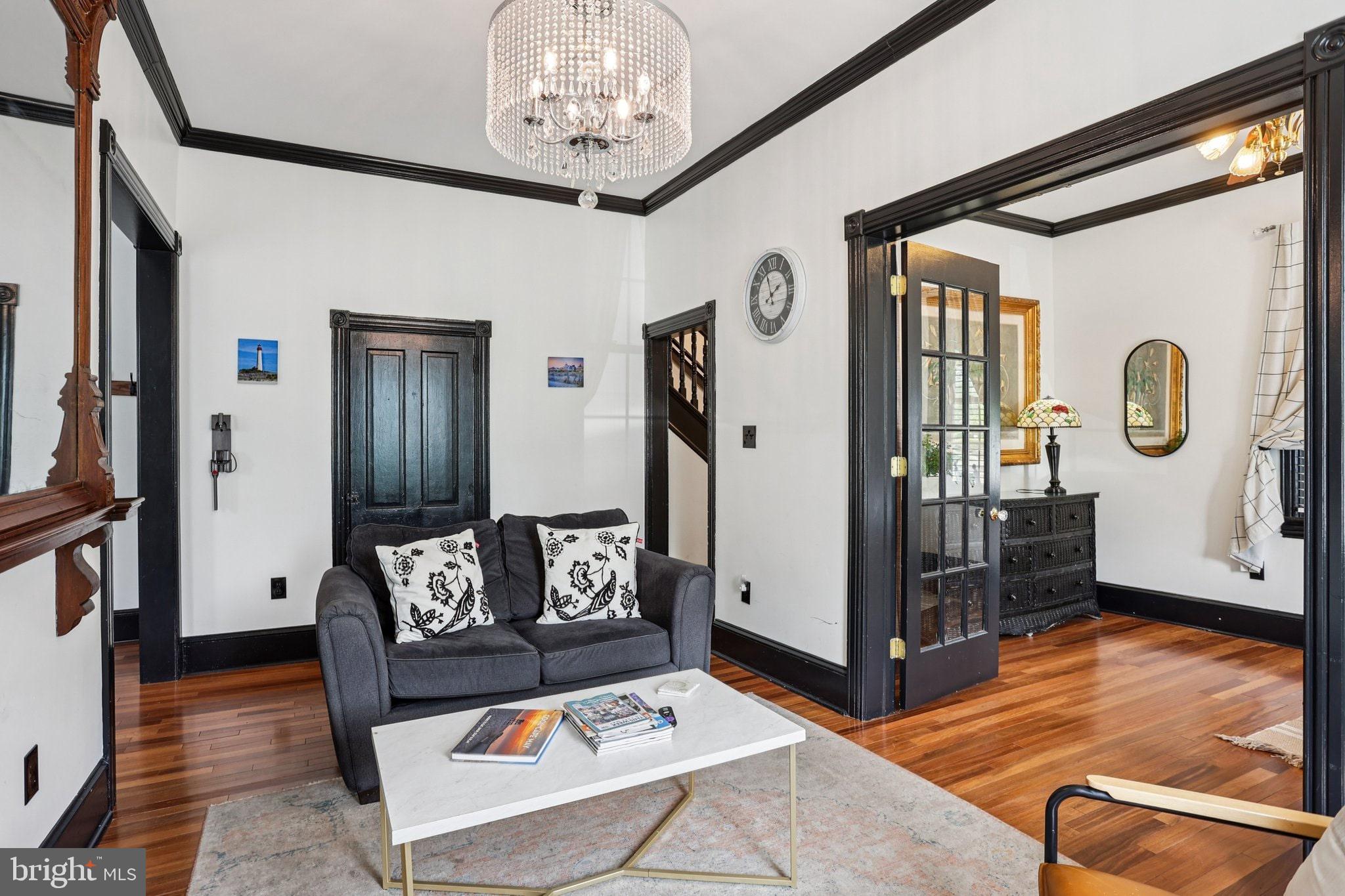 414 Broadway Cape May, NJ 08204 - Photo 28 of 48 a living room with furniture and a chandelier